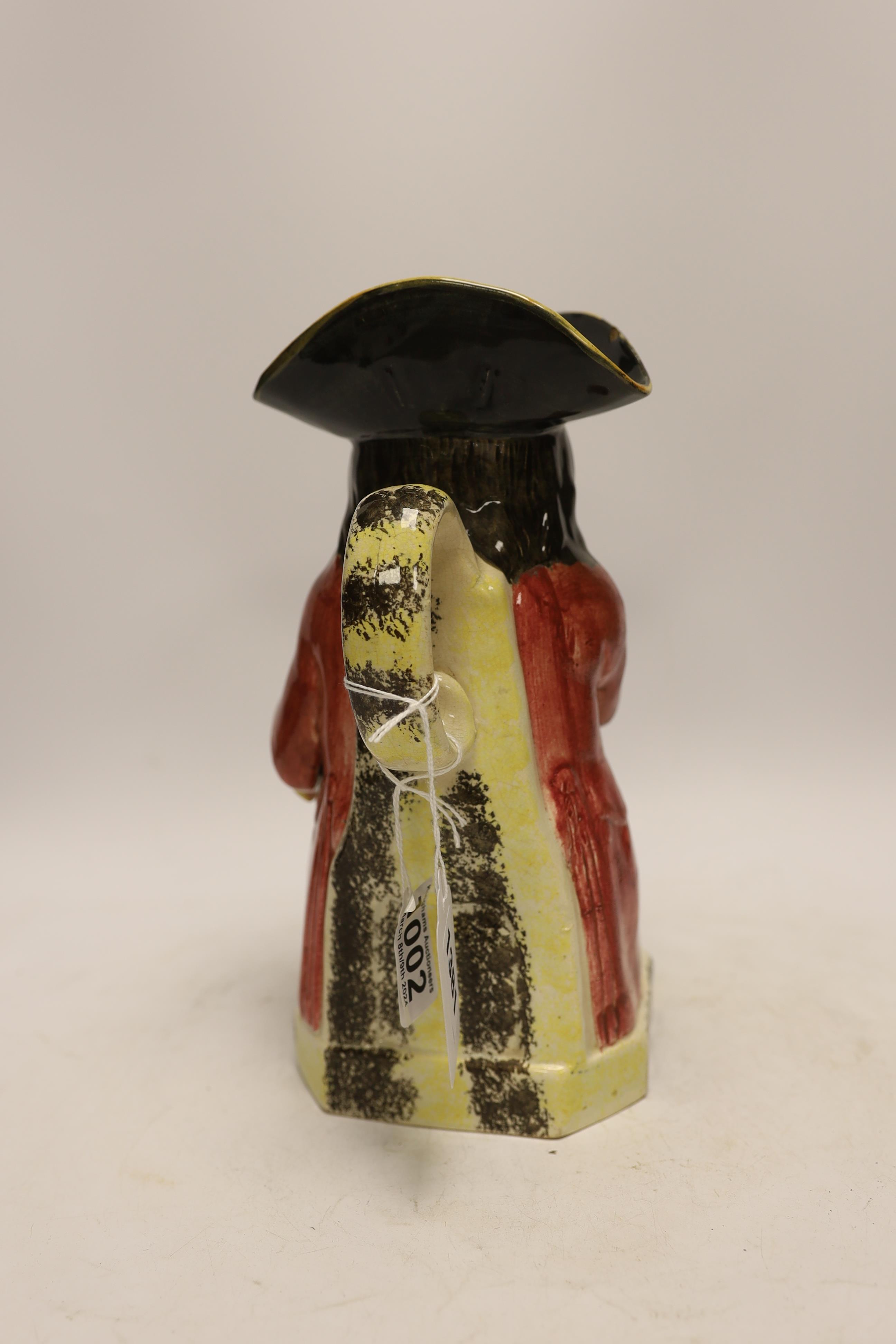 A Yorkshire Toby jug, c.1800, modelled holding a frothing jug, pink coat and green breeches, 26.5cm high